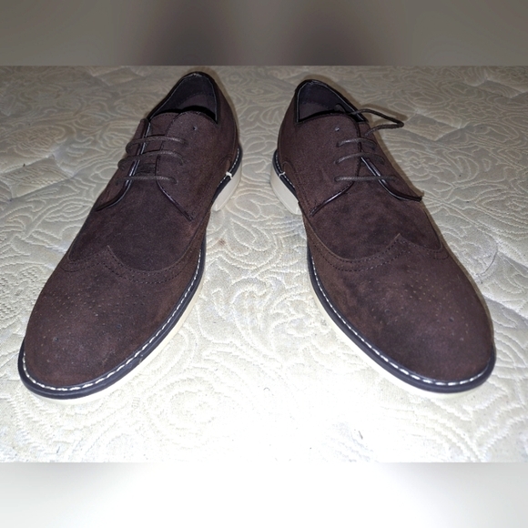 A pair of Franco Vanucci brown suede men\'s loafers in a size 10.5. EUC.